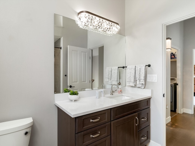 bathroom with vanity, an inviting chandelier, toilet, and hardwood / wood-style flooring