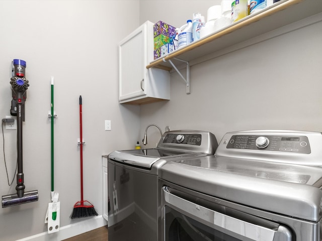 laundry room with cabinets and washer and clothes dryer