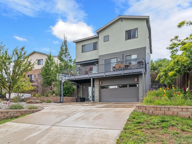 view of front of property with a balcony and a garage