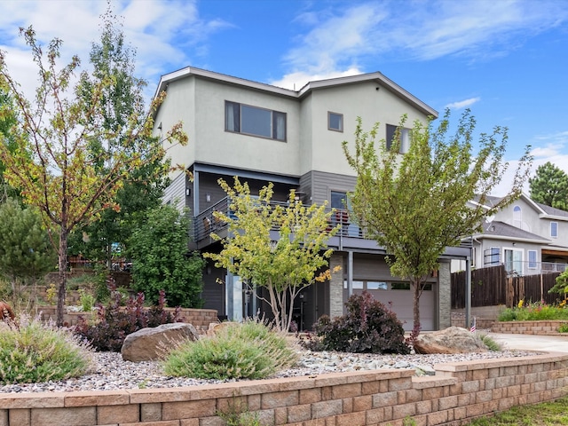 view of front of home featuring a garage and a balcony