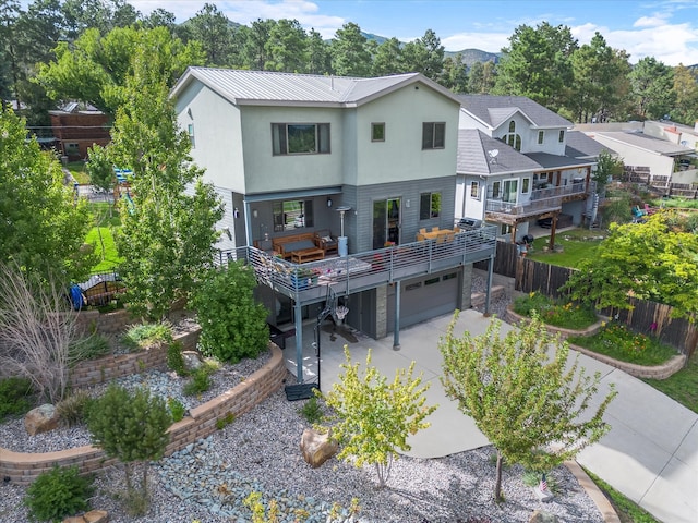 rear view of house featuring a garage