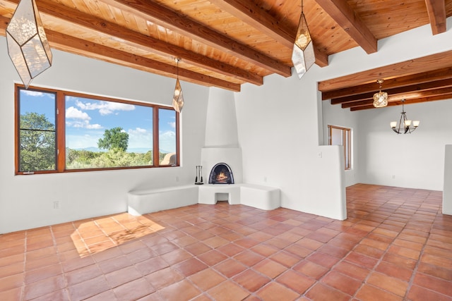 unfurnished living room with beamed ceiling, a fireplace, tile patterned floors, and wood ceiling