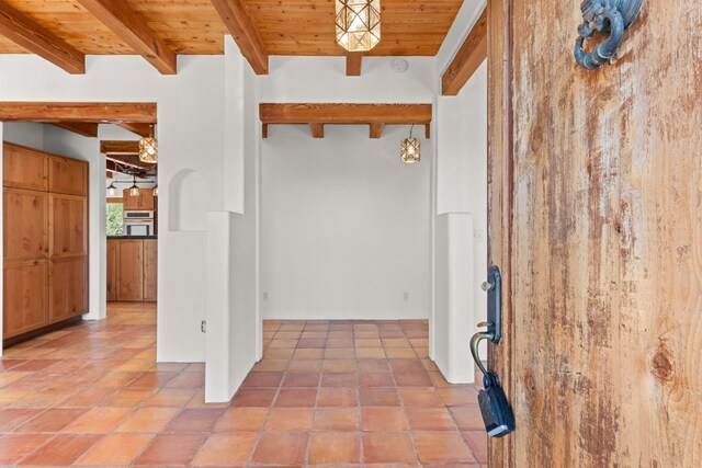 tiled entrance foyer with wooden ceiling and beamed ceiling