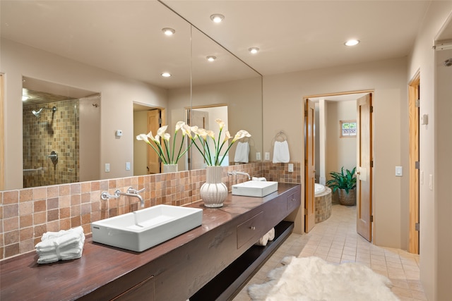 bathroom with decorative backsplash, tile patterned flooring, vanity, and a shower with door