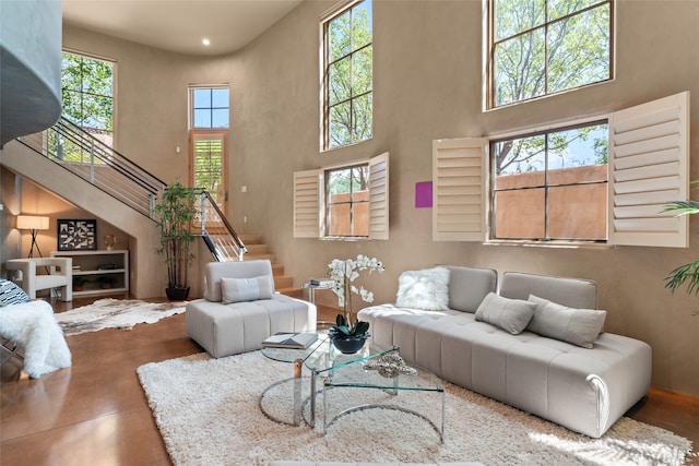 living room featuring a towering ceiling