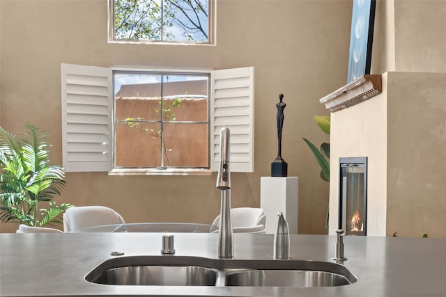 kitchen with a towering ceiling and sink