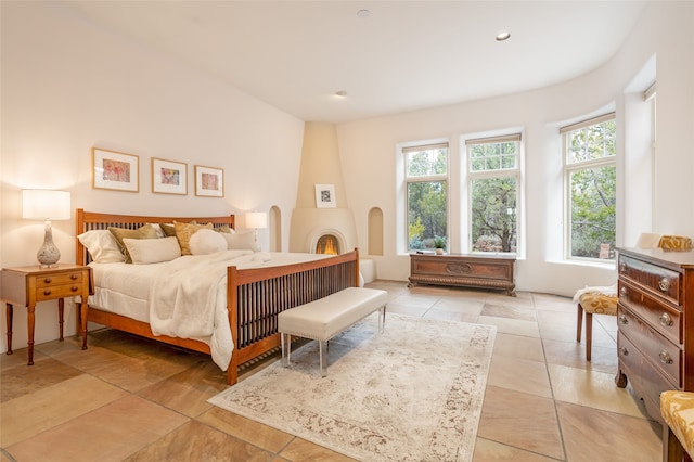 tiled bedroom with a fireplace