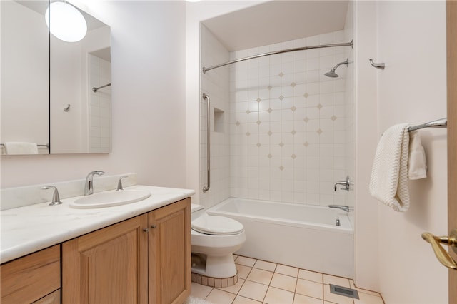 full bathroom featuring tile patterned flooring, vanity, toilet, and tiled shower / bath