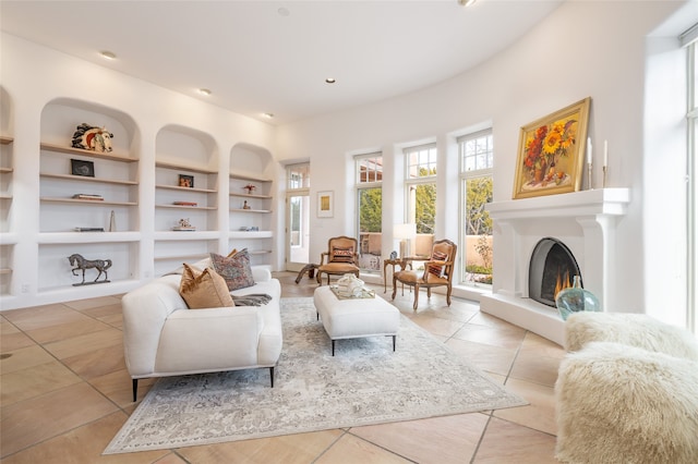 sitting room with light tile patterned floors and built in features