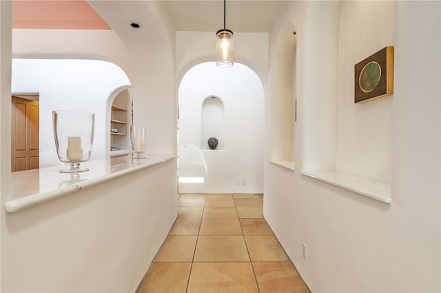 hallway featuring light tile patterned floors