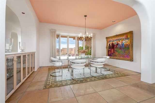 tiled dining area featuring a notable chandelier