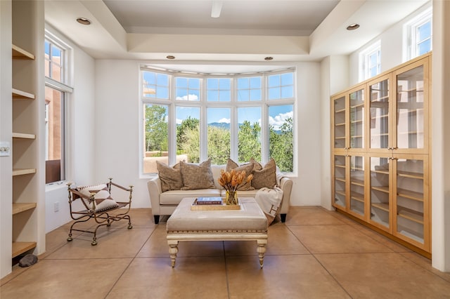 sunroom with a tray ceiling and a healthy amount of sunlight