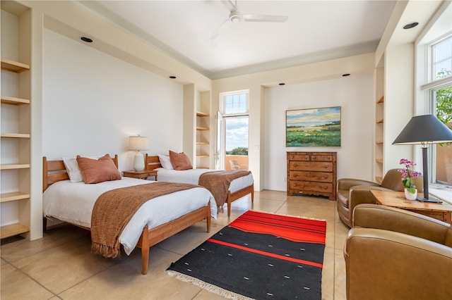 tiled bedroom featuring ceiling fan