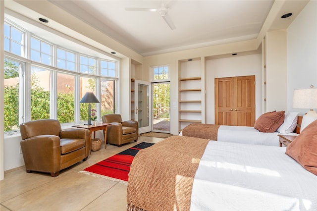 tiled bedroom with access to outside, multiple windows, and ceiling fan