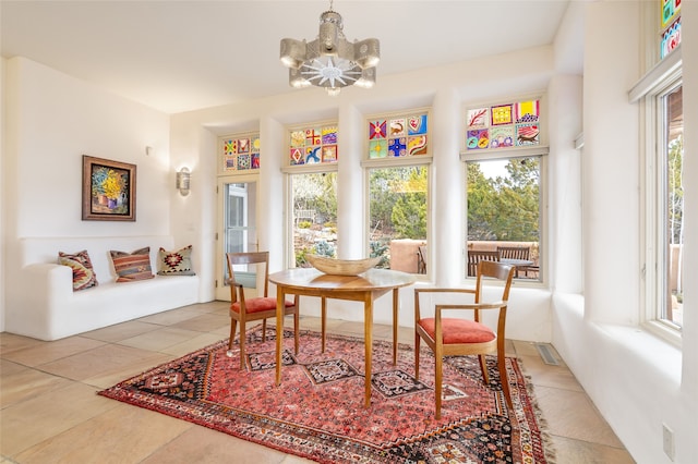 sunroom with a chandelier and a healthy amount of sunlight