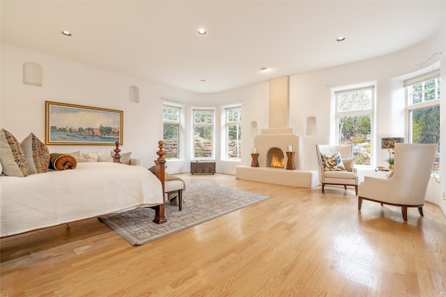 bedroom with light wood-type flooring and multiple windows