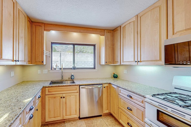 kitchen with dishwasher, a textured ceiling, white gas stove, sink, and light brown cabinetry