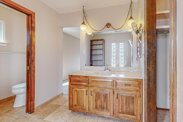 bathroom featuring vanity, toilet, and tile patterned floors