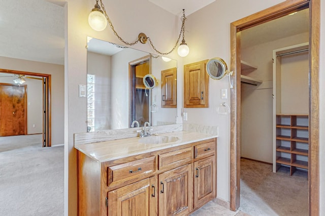 bathroom featuring ceiling fan and vanity