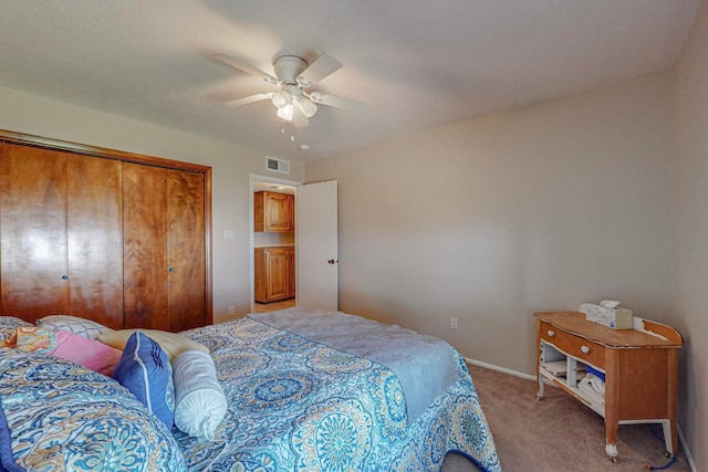 bedroom featuring ceiling fan, light colored carpet, and a closet