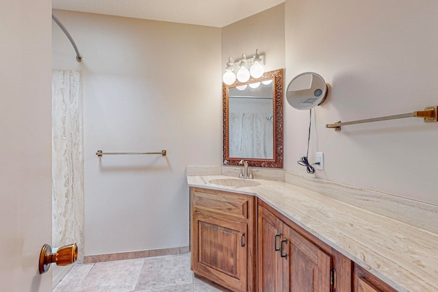 bathroom with curtained shower, vanity, and tile patterned floors