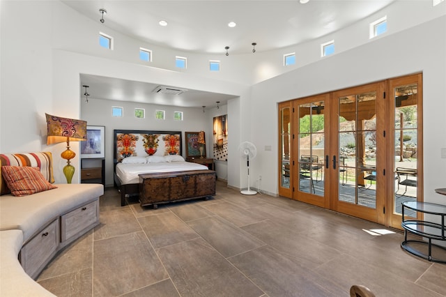 tiled bedroom with high vaulted ceiling, access to outside, and french doors