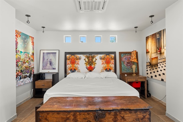 tiled bedroom with a wall mounted air conditioner