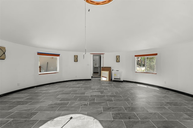 unfurnished living room with dark tile patterned floors