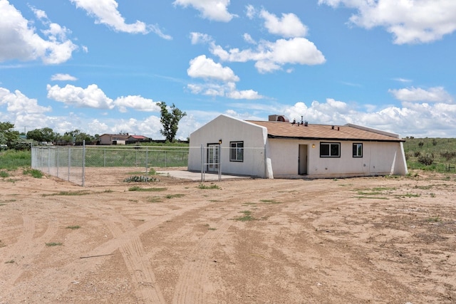 rear view of property with fence