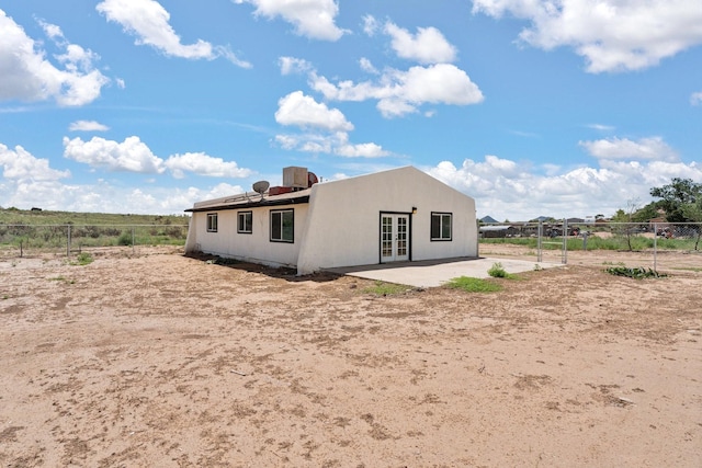 back of house featuring fence, french doors, and a patio