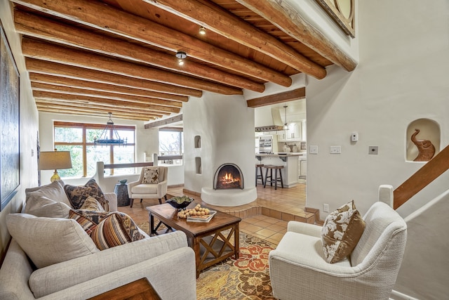 tiled living room with beamed ceiling and a chandelier