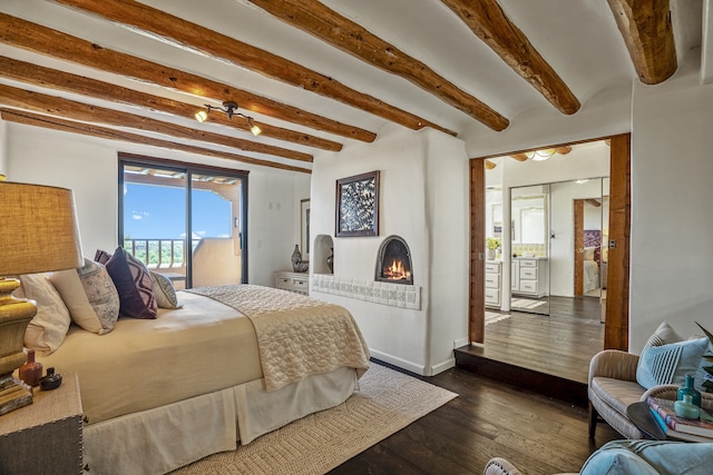 bedroom with access to exterior, beam ceiling, and dark hardwood / wood-style floors