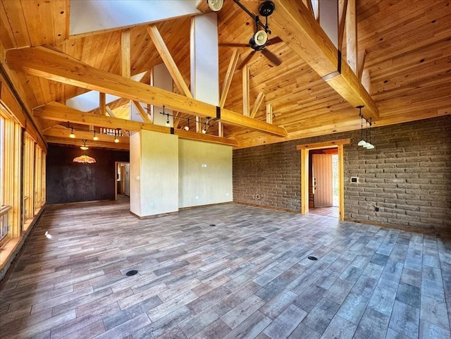 125 Tierra Del Dios, Rowe, NM 87562 - unfurnished living room with wood ceiling, vaulted ceiling with beams, wood finished floors, and brick wall