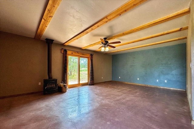 125 Tierra Del Dios, Rowe, NM 87562 - unfurnished living room featuring beam ceiling, finished concrete flooring, baseboards, ceiling fan, and a wood stove