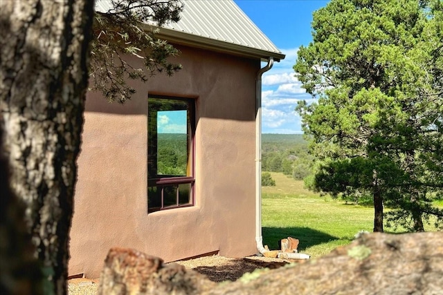 125 Tierra Del Dios, Rowe, NM 87562 - view of property exterior featuring stucco siding and a lawn