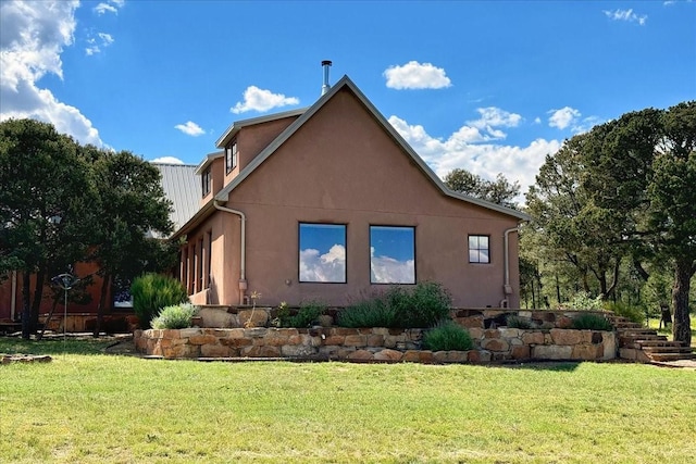 125 Tierra Del Dios, Rowe, NM 87562 - view of side of home featuring a lawn and stucco siding