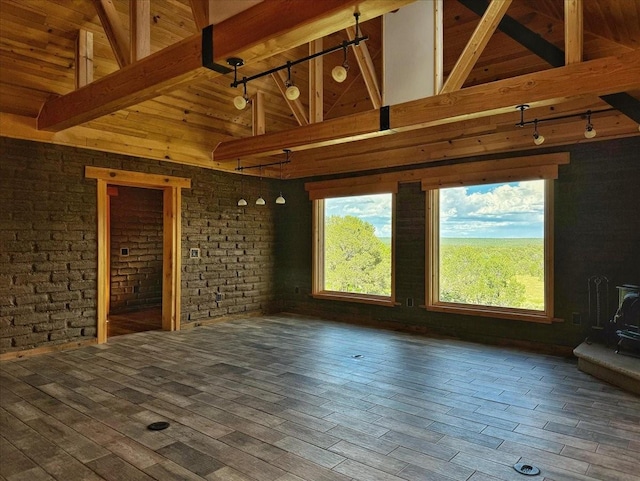 125 Tierra Del Dios, Rowe, NM 87562 - unfurnished living room with beam ceiling, a healthy amount of sunlight, and high vaulted ceiling