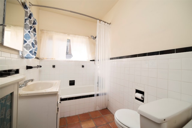 full bathroom featuring vanity, shower / bath combo with shower curtain, tile patterned floors, tile walls, and toilet