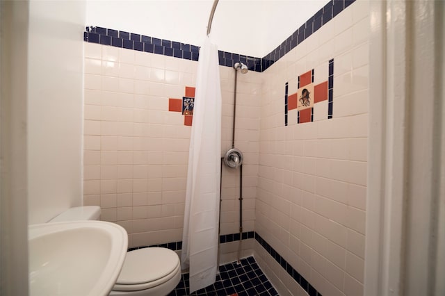 bathroom with sink, tile patterned flooring, toilet, and curtained shower