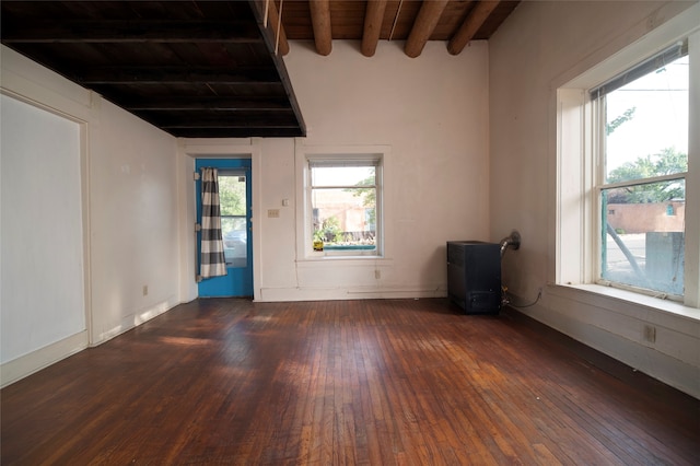 spare room featuring wood ceiling, beam ceiling, and dark hardwood / wood-style flooring