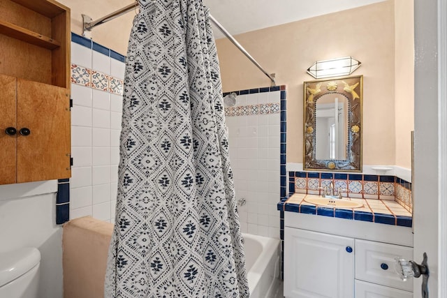 full bathroom featuring vanity, toilet, and tiled shower / bath