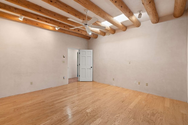 unfurnished room with beamed ceiling, ceiling fan, and light hardwood / wood-style floors