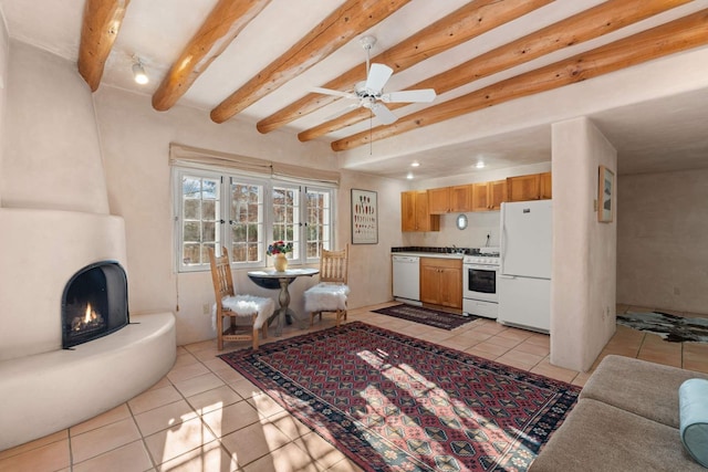 living room with ceiling fan, french doors, beamed ceiling, and light tile patterned flooring