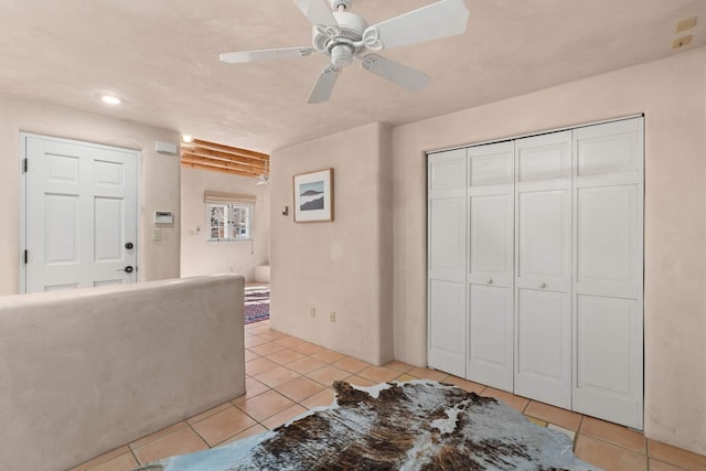 tiled foyer entrance with ceiling fan