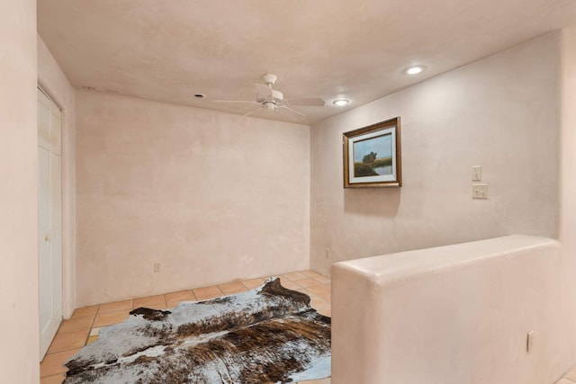 interior space featuring tile patterned flooring and ceiling fan