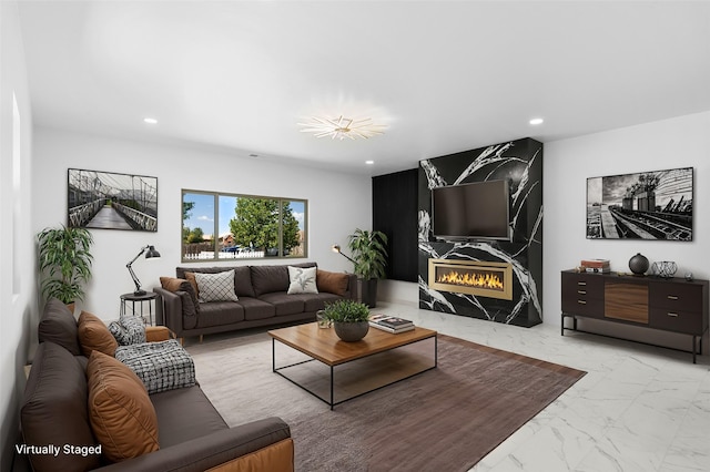 living room featuring a high end fireplace