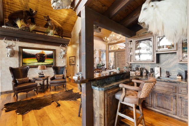 kitchen with vaulted ceiling with beams, light hardwood / wood-style floors, wooden ceiling, sink, and an inviting chandelier