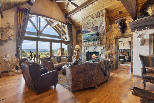 living room with wood ceiling, beam ceiling, and hardwood / wood-style flooring