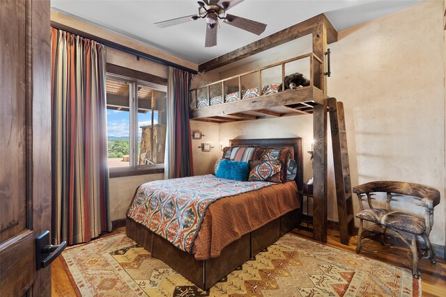 bedroom with ceiling fan and light hardwood / wood-style floors