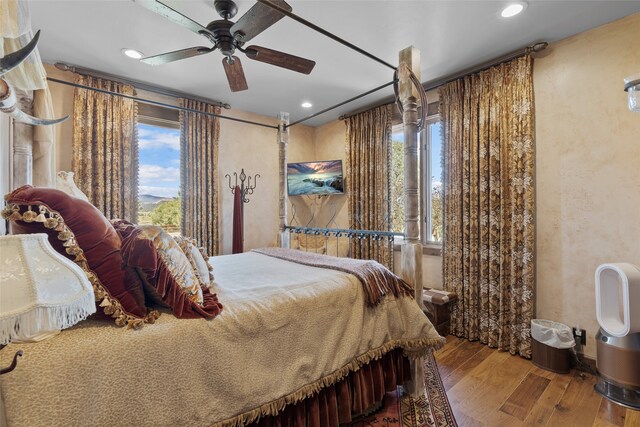 bedroom featuring hardwood / wood-style flooring and ceiling fan